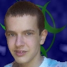 A selfie of my face in front of a green and blue AiChaos logo.