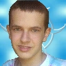 A selfie of my face in front of a light blue and white AiChaos logo.