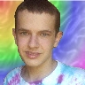 A selfie of my face in front of rainbow colors.